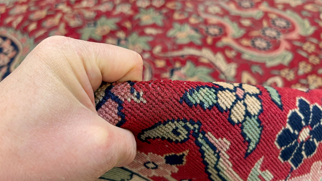 hand holding Indian Wool rug