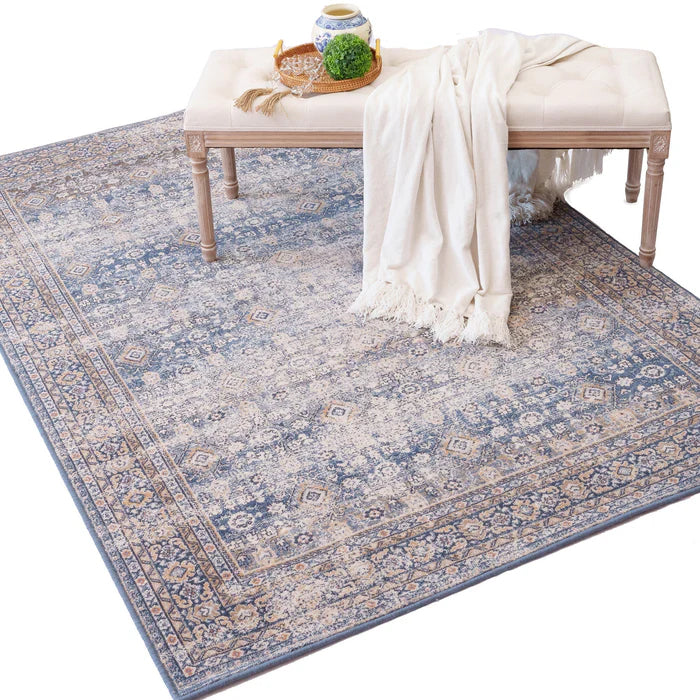 White settee on blue toned imported area rug made from New Zealand wool from Kirishian Rugs