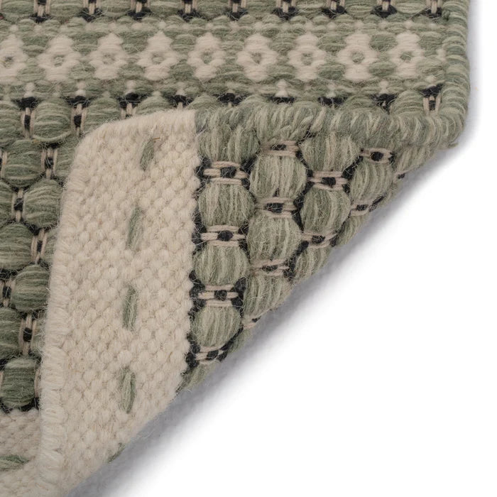 Upturned corner details of Alpine Collection Green area rug