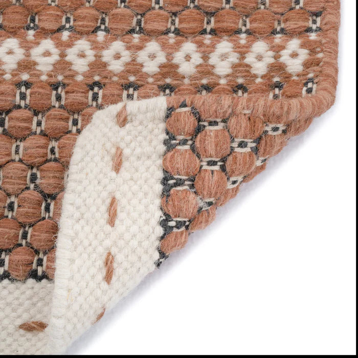 Edge turned up on area rug | Alpine Collection Rust