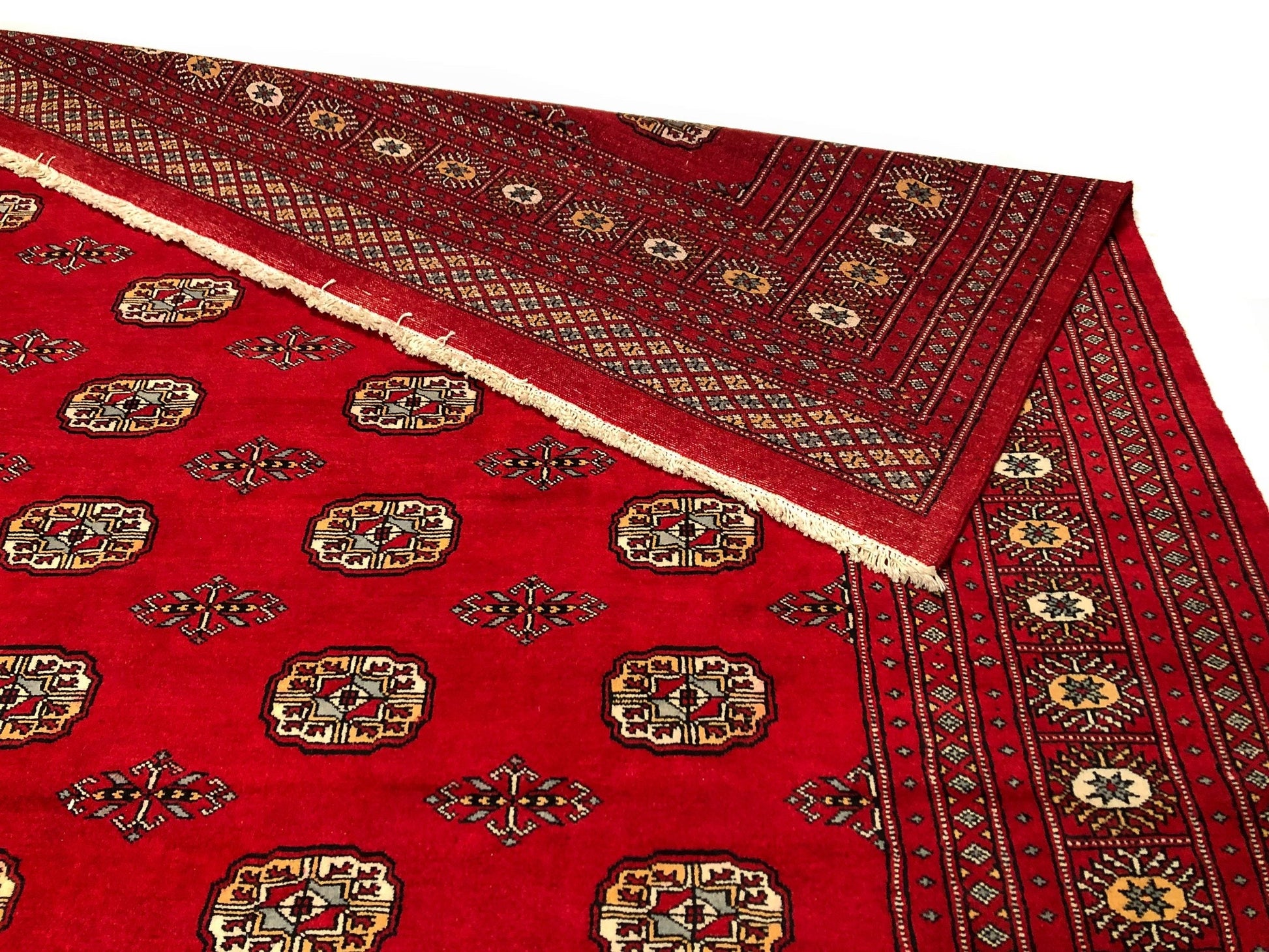 Bokhara (9x12) rug flipped at the corner to show the bottom and top of the area rug