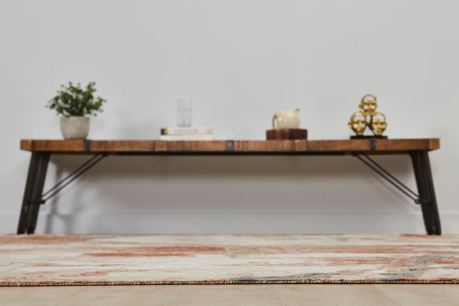 Floor angle/view of Rust/Sand Abstract Area Rug -Vaughn Collection with table in background