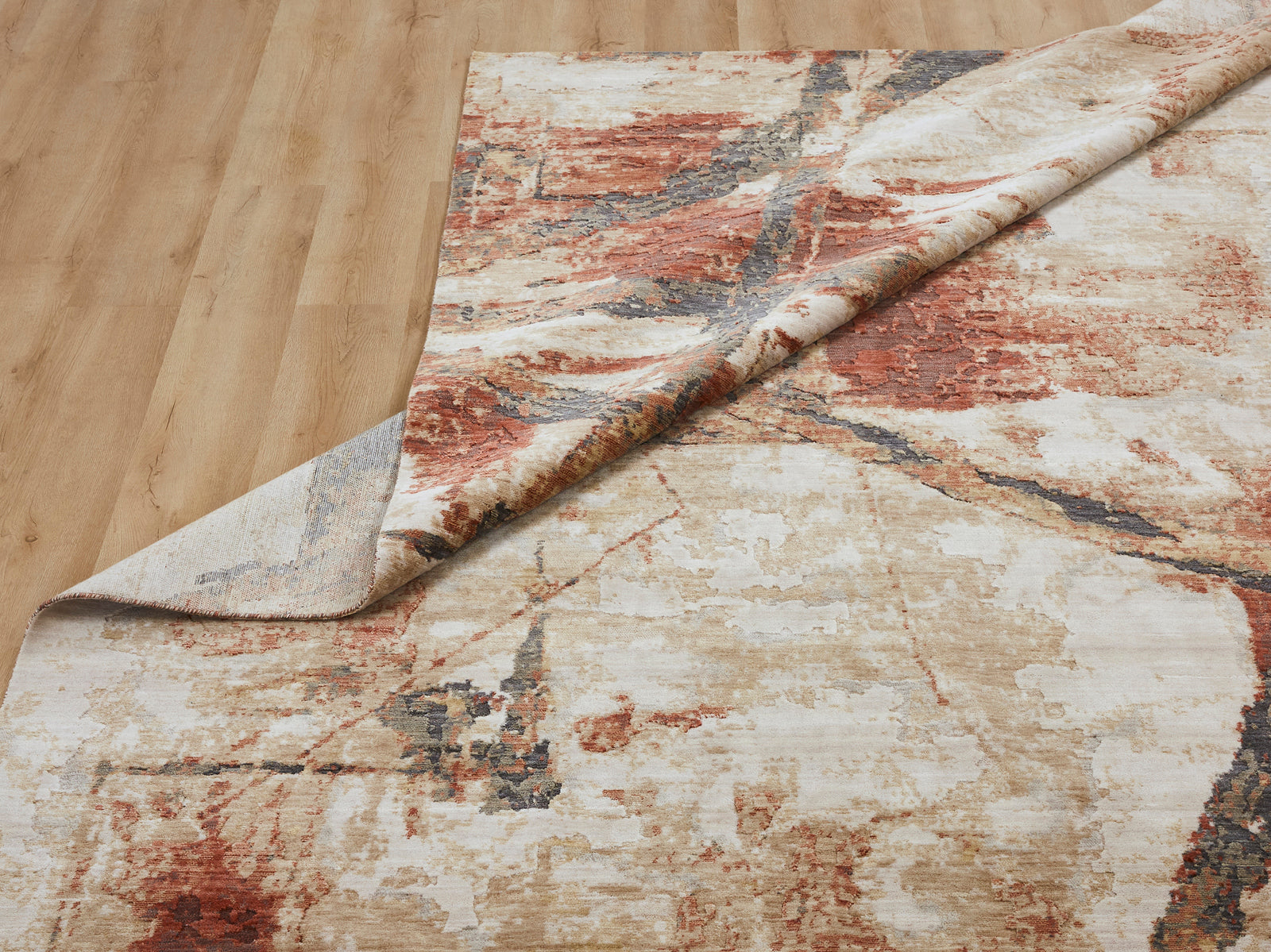 Corner turned for details of bottom/top of Rust/Sand Abstract Area Rug -Vaughn Collection